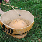 Playing water gourd drum