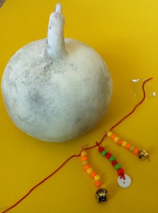 white gourd + necklace - shekere being made